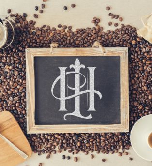 The hook and Ladder Logo on a chalkboard with coffee beans underneath